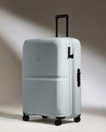 a white suitcase with black wheels