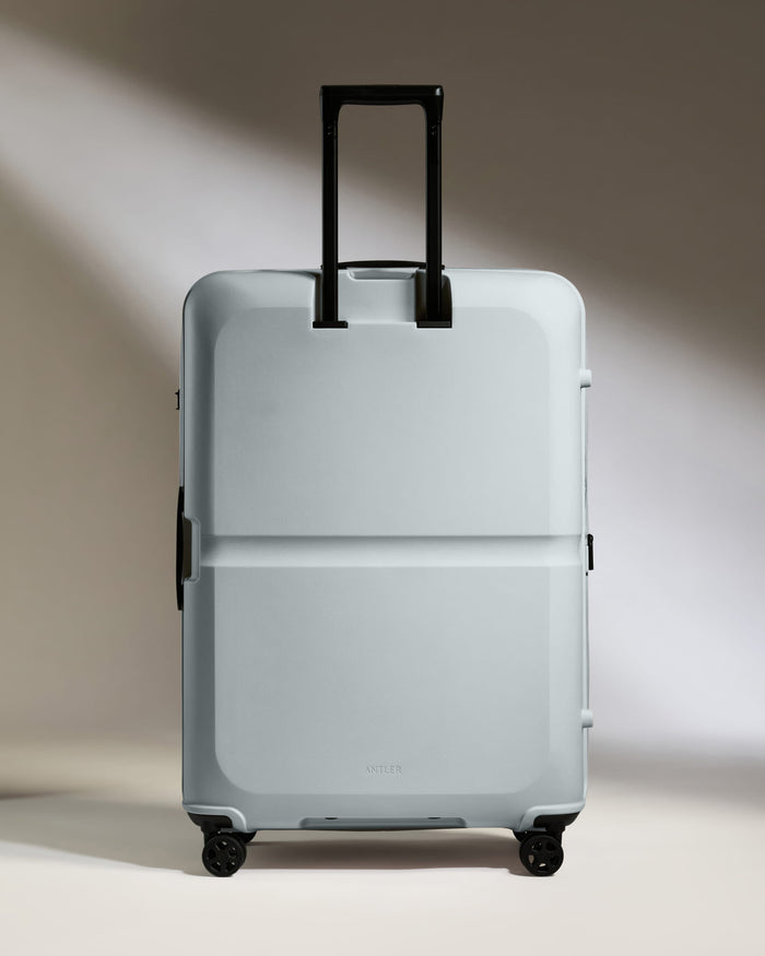 a white suitcase with black handles