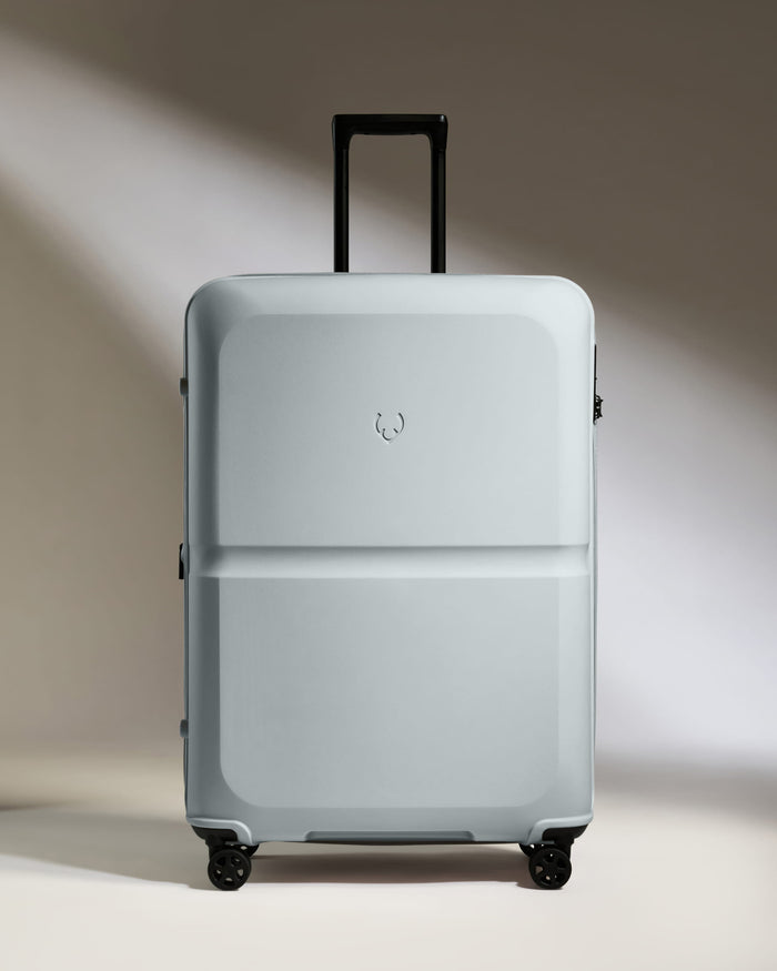 a white suitcase with black wheels