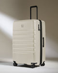 a white suitcase with black wheels