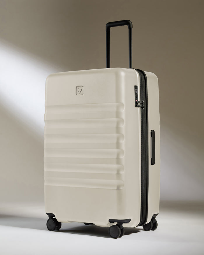 a white suitcase with black wheels