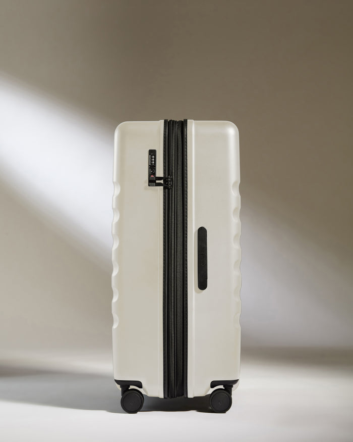 a white suitcase with wheels