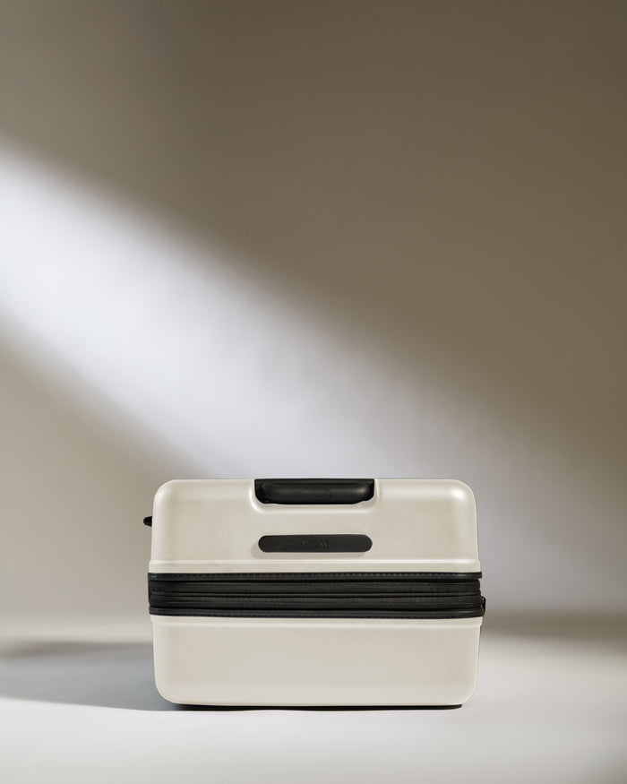 a white suitcase with a black zipper