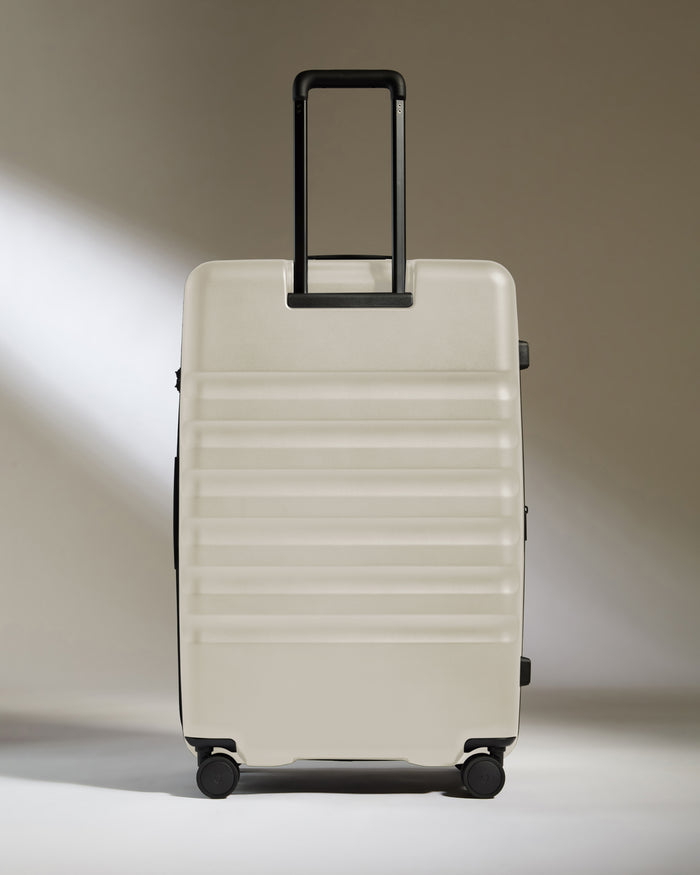 a white suitcase with black handles