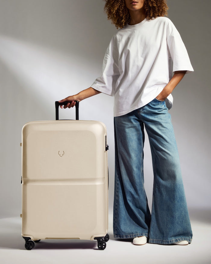 a woman standing with a suitcase