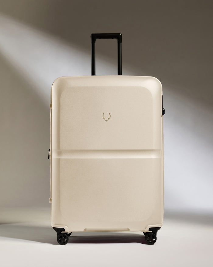 a white suitcase with black wheels