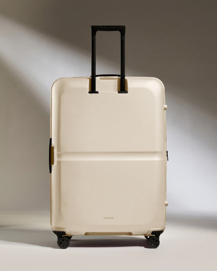 a white suitcase with black handles