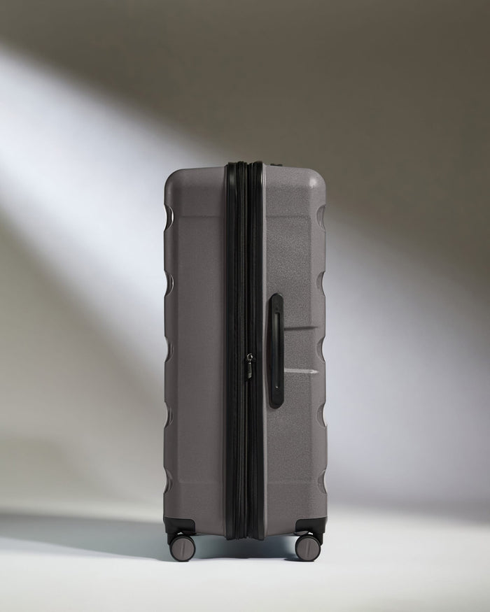 Antler Luggage -  Expandable Large Suitcase in Gloss Gull Grey - Logo Stripe - Expanding Rollercase | Large 4W Expandable Large Suitcase in Gloss Gull Grey - Logo Stripe