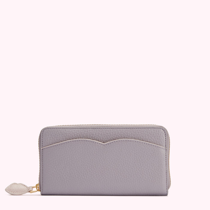 A lavender zip-around wallet on a white background.