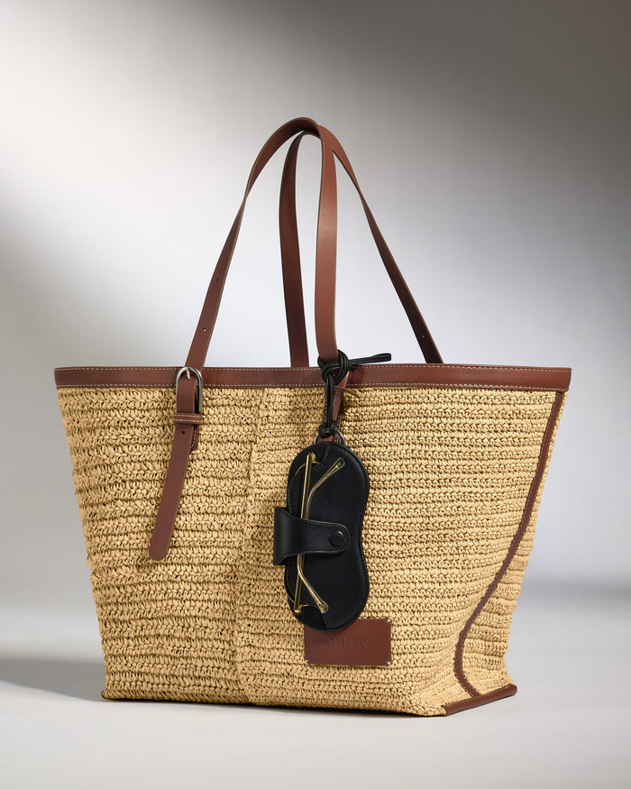 a brown and tan bag with a black object on it
