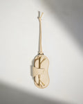 a white pouch with gold hair clips on a string