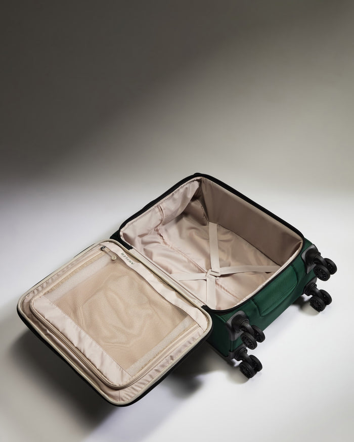 a green suitcase with wheels