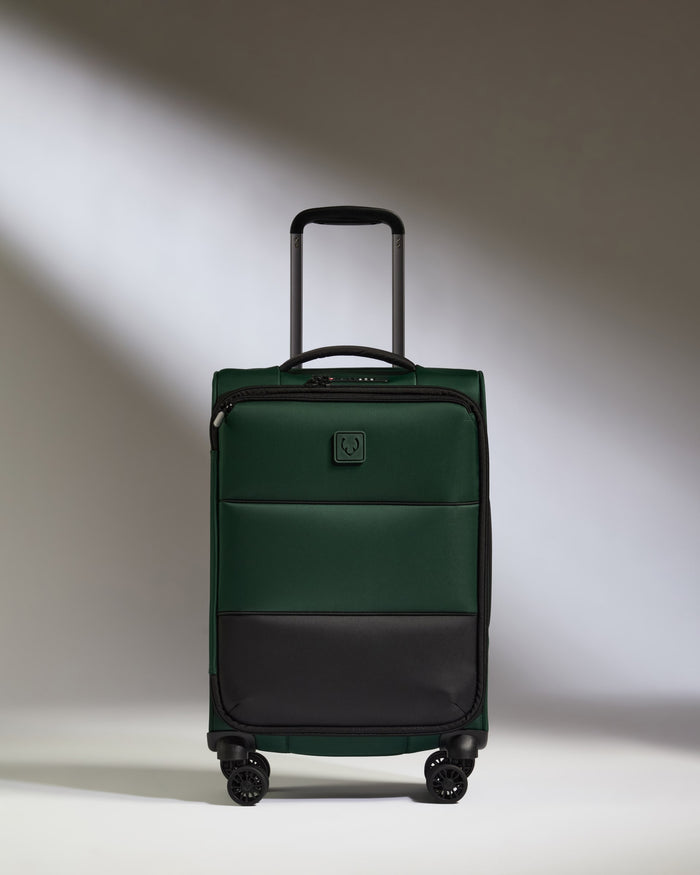 a green suitcase with wheels