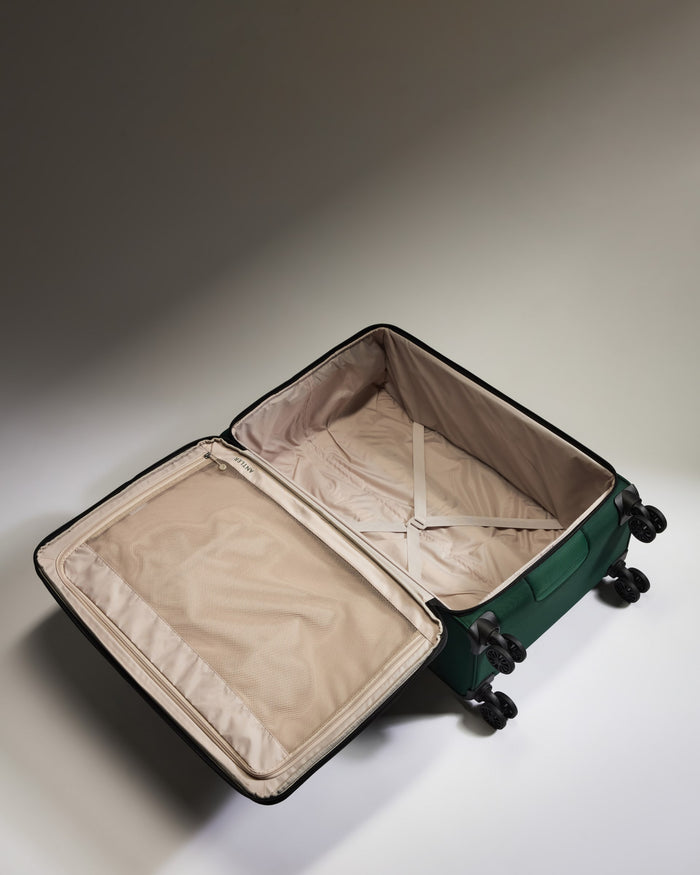 a green suitcase with wheels