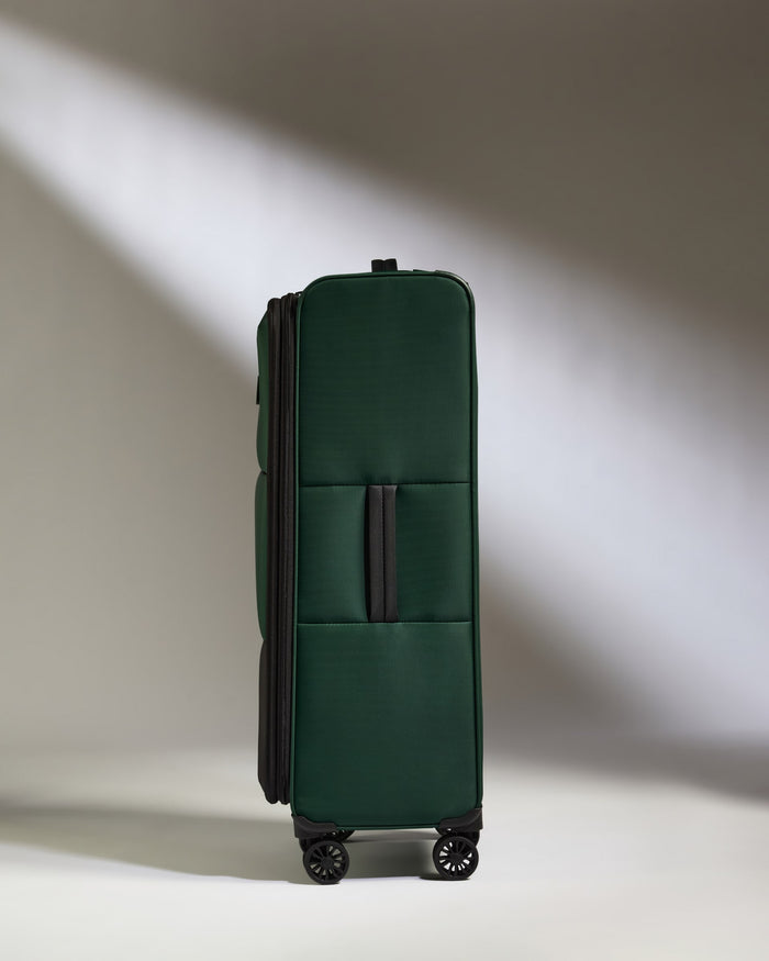 a green suitcase with wheels