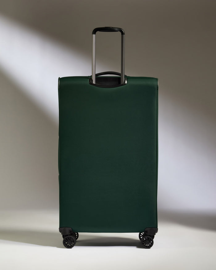 a green suitcase with wheels