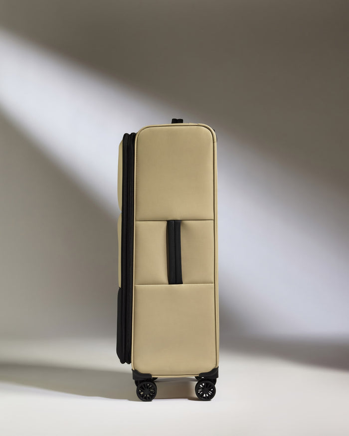 a tan suitcase with wheels