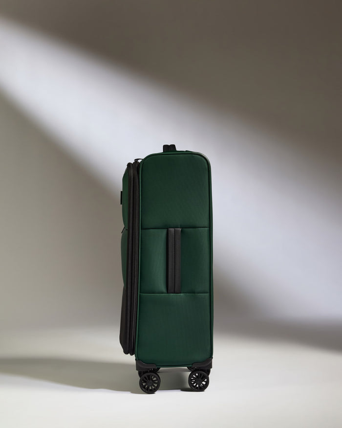 a green suitcase with wheels