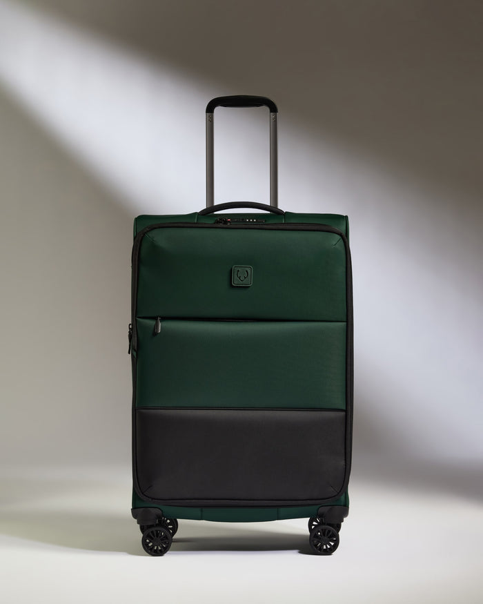 a green suitcase with wheels