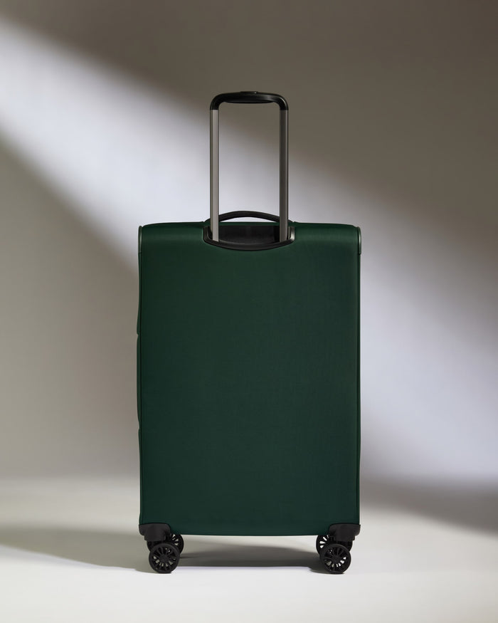 a green suitcase with wheels