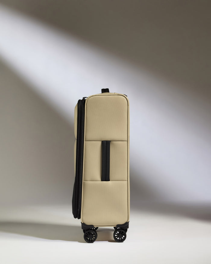 a tan suitcase with wheels
