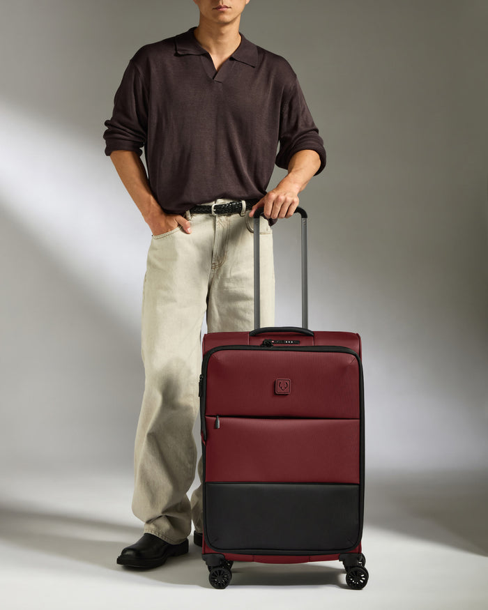 a man standing next to a suitcase