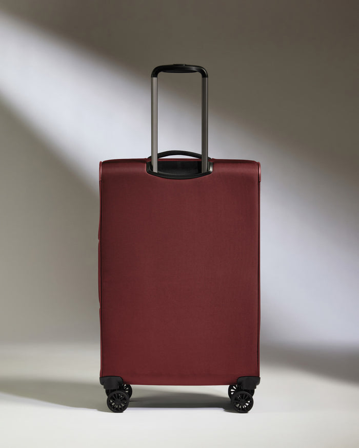 a red suitcase with a handle