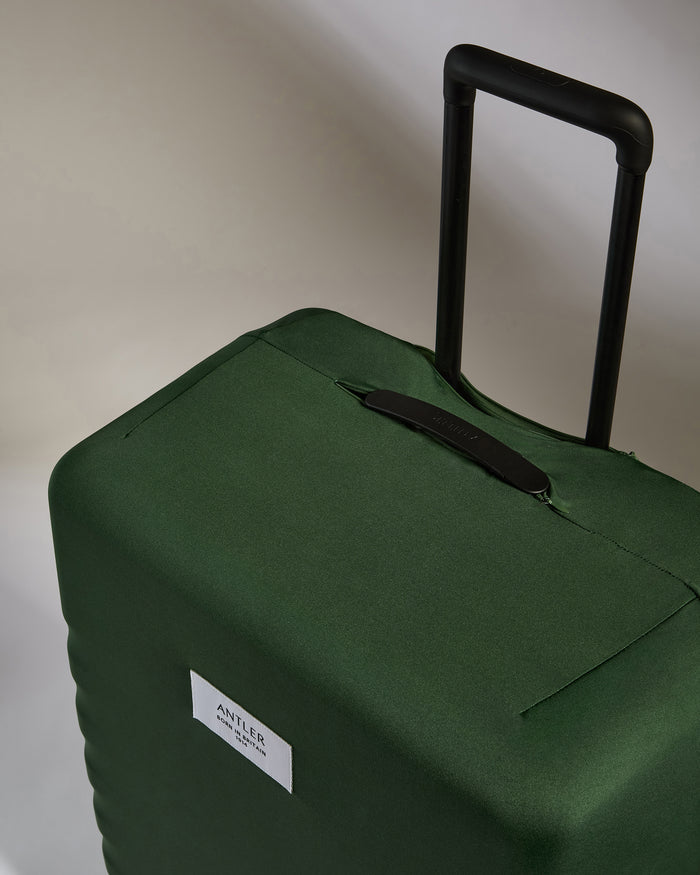 a green suitcase with handle