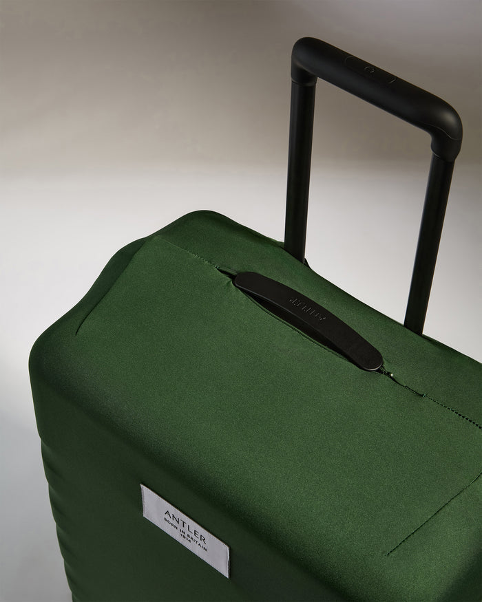 a green suitcase with handle