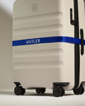 a luggage with a blue ribbon