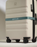 a luggage with a ribbon around it