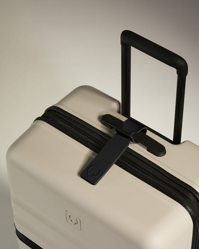 a white suitcase with black handle