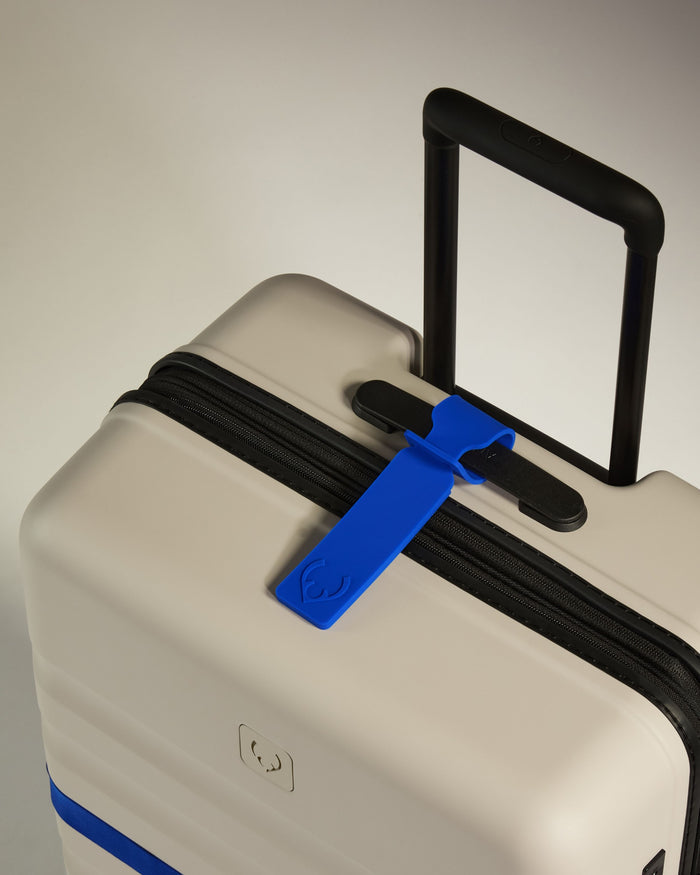 a luggage bag with a blue tag