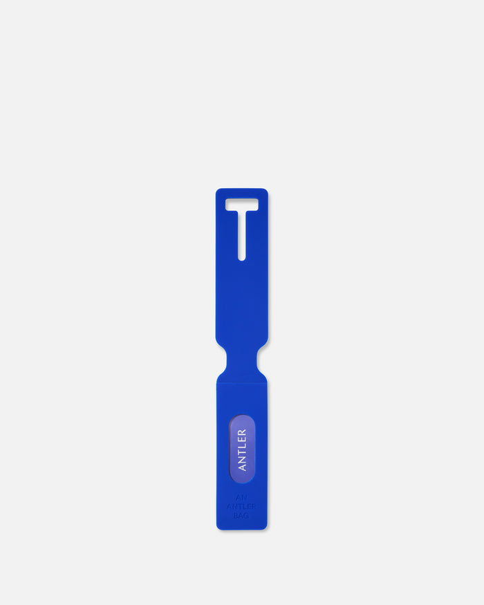 a blue plastic tool with a white label