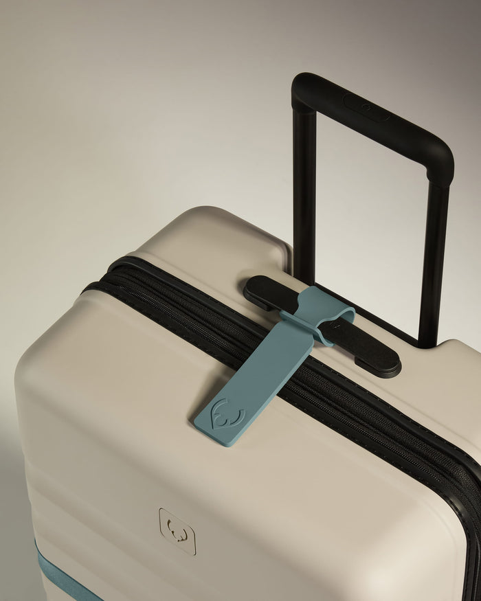 a luggage with a blue tag on it