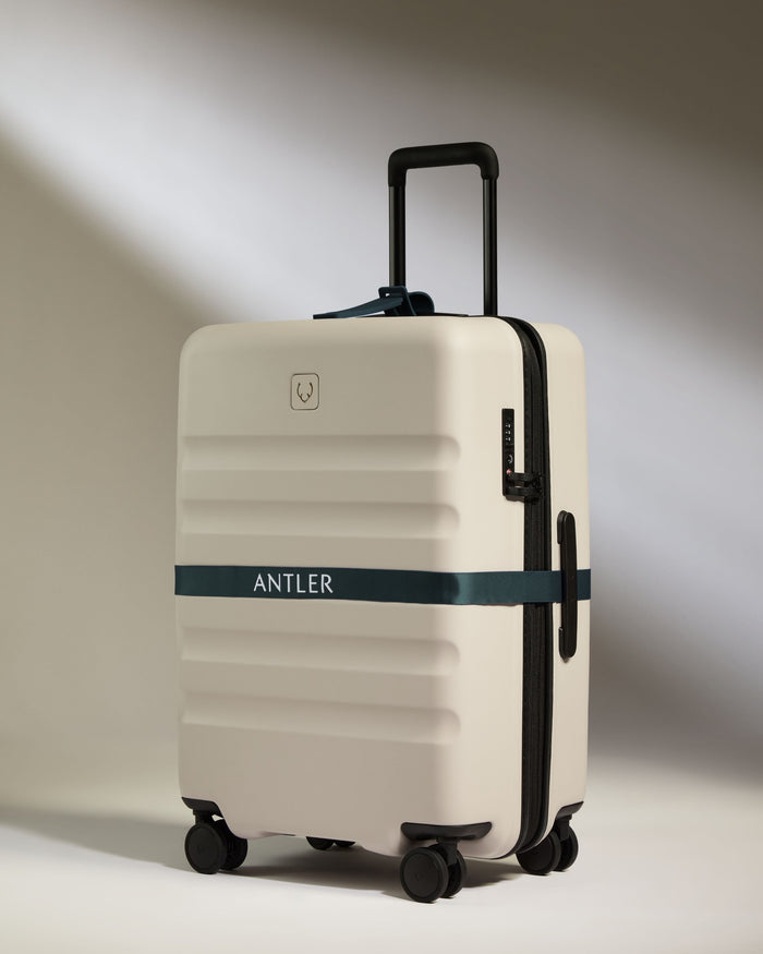a white suitcase with a blue band around it