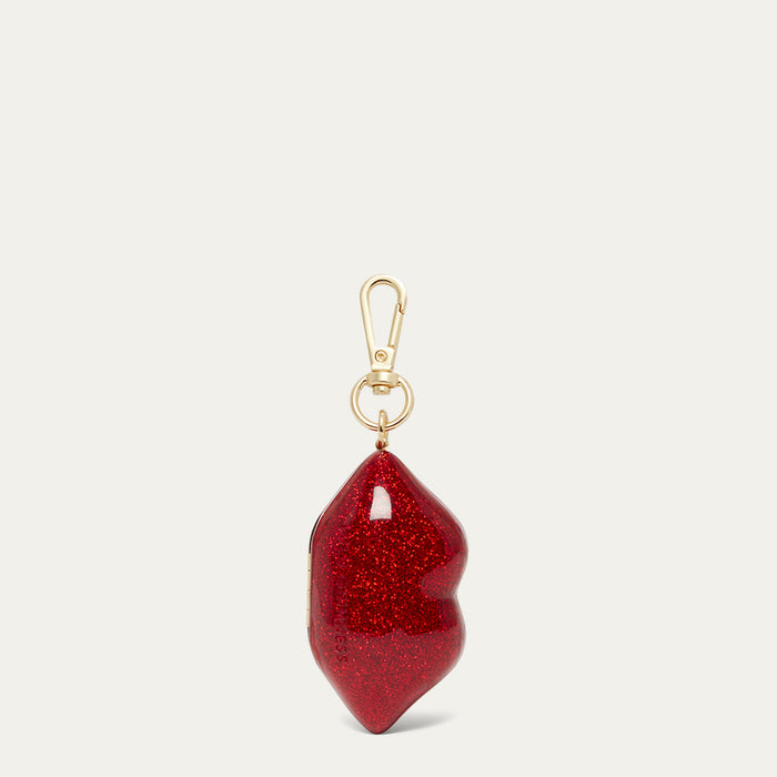 Red glittery red lip keychain with gold clasp on a white background