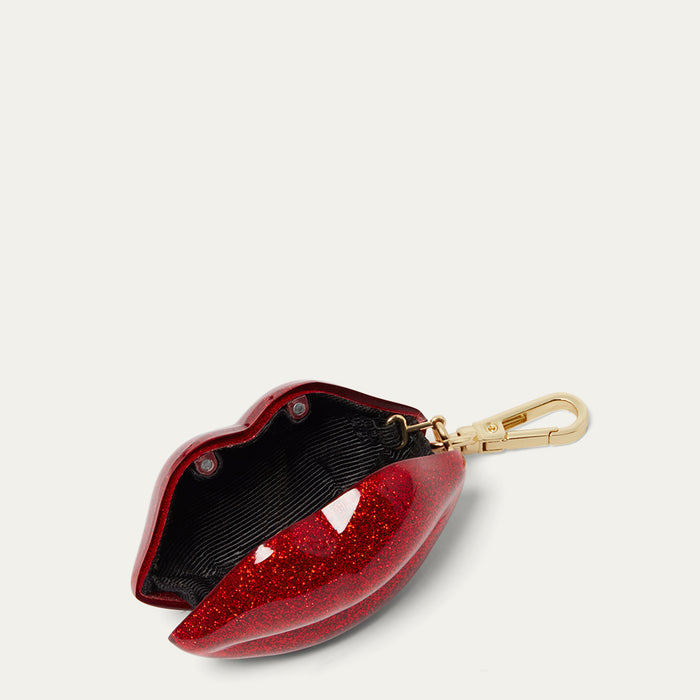 Red glittery lip-shaped keychain on a light gray background