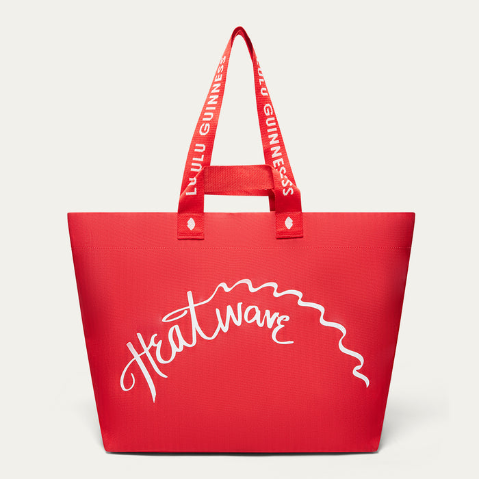 A red tote bag with white script text reading 'Heatwave' across the front and red shoulder straps with 'LULU GUINNESS' in white, shown on a light gray background.