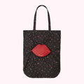Black tote bag with red lips pattern and a large red lip-shaped pocket.