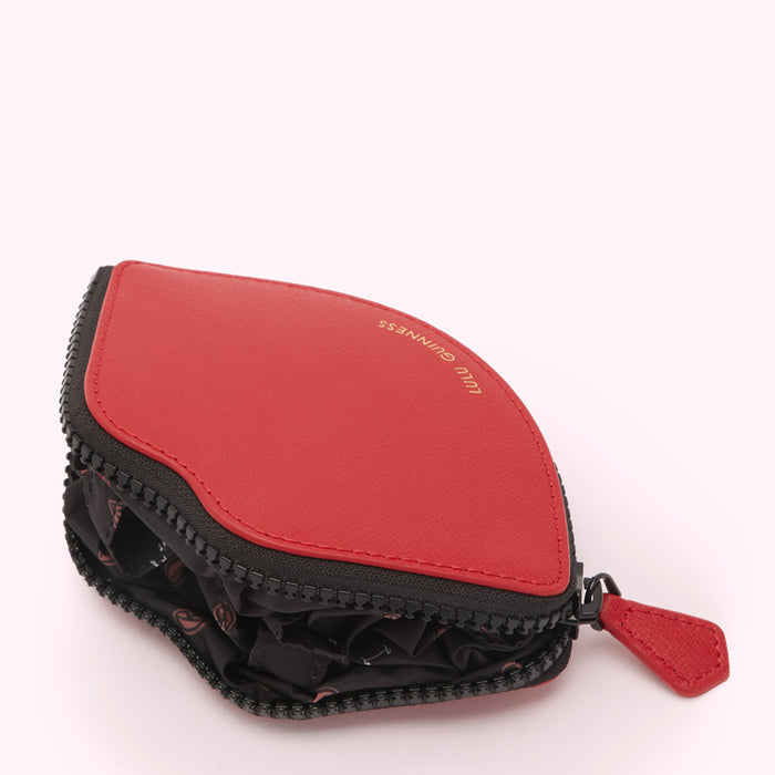 Red Lulu Guinness lip-shaped zipped pouch on white background.