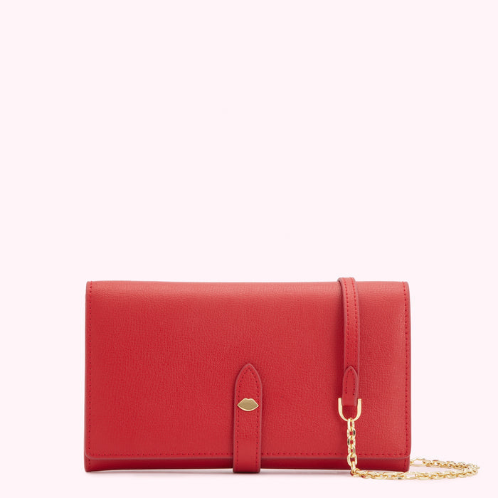 Red leather wallet on a white background with a gold chain strap.