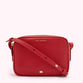 Red Lulu Guinness crossbody bag with gold-toned hardware.