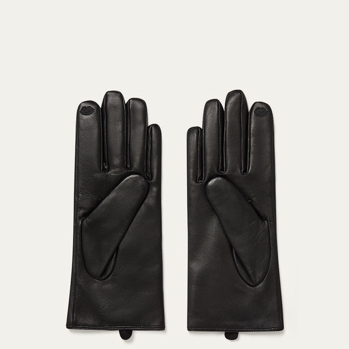 Pair of black leather gloves on a light gray background