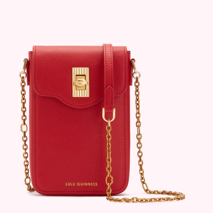 Red Lulu Guinness crossbody bag with gold chain strap and clasp.