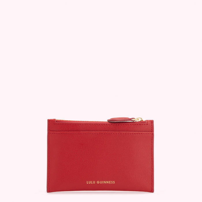 Red leather Lulu Guinness zip-around cardholder against a white background.