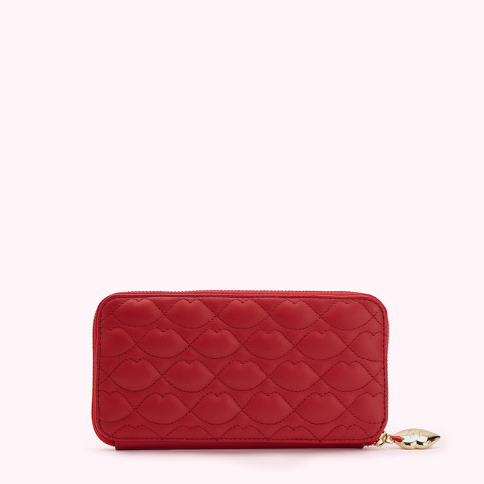 Red quilted zip-around wallet with lip pattern.