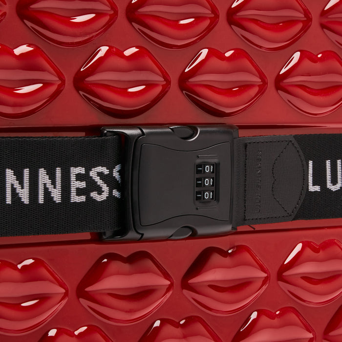 Close-up of a red suitcase with a lip-shaped pattern and a black TSA-approved combination lock.