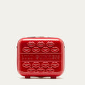 Red vanity case with lips pattern and 'Lulu Guinness' branding on a light gray background