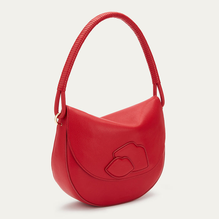 A red Lulu Guinness leather handbag with a curved shape and three lips on the front.